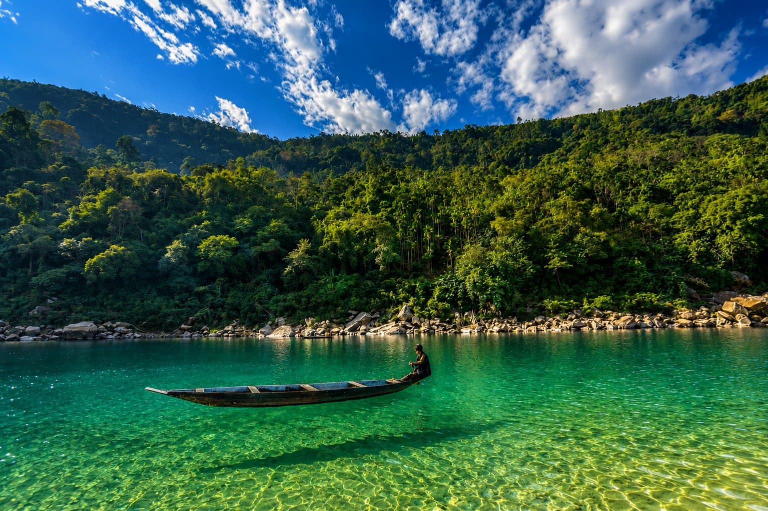 A boat appearing to float on the crystal-clear water of the Dawki river