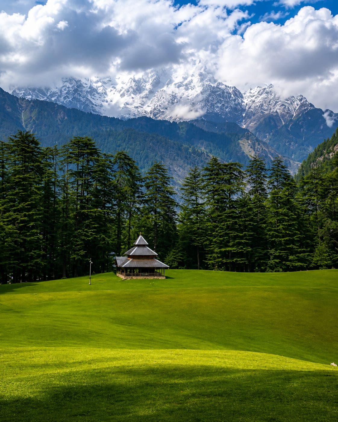 Shangarh meadows near the Great Himalayan National Park, with the wooden temple