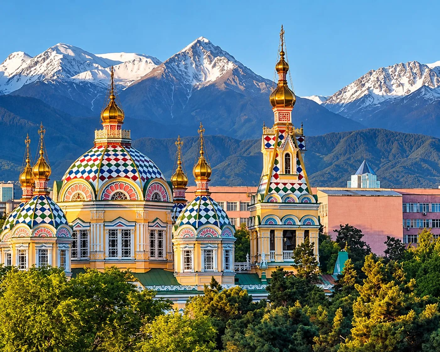 Zenkov Cathedral's colourful onion domes in Almaty, with the snow-capped Tian Shan mountains behind