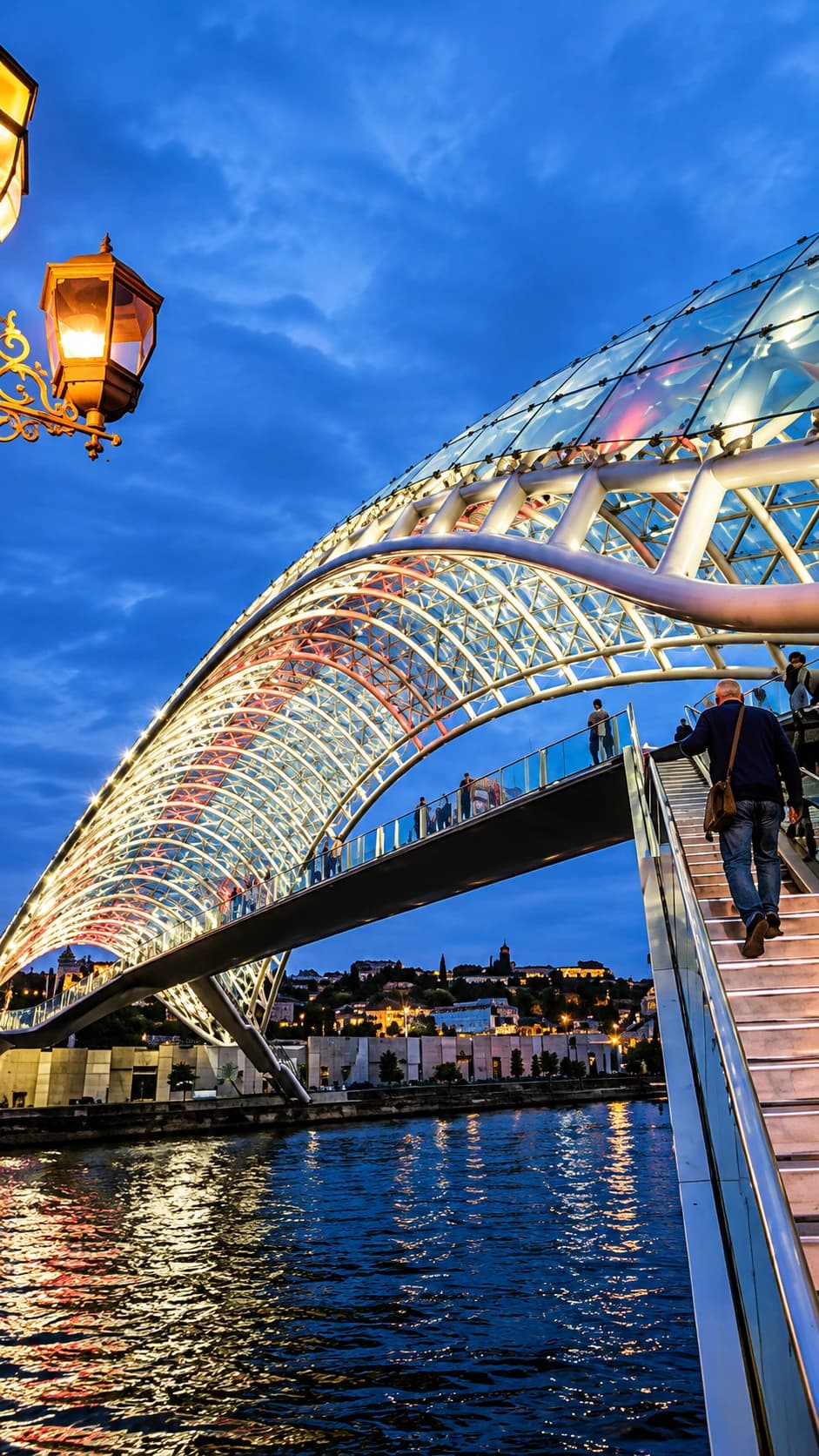 The Bridge of Peace illuminated at night over the Mtkvari river in Tbilisi